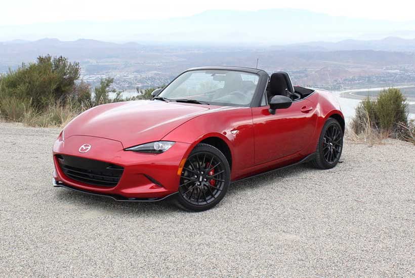 Red Mazda MX-5 Miata convertible, by a overlooking